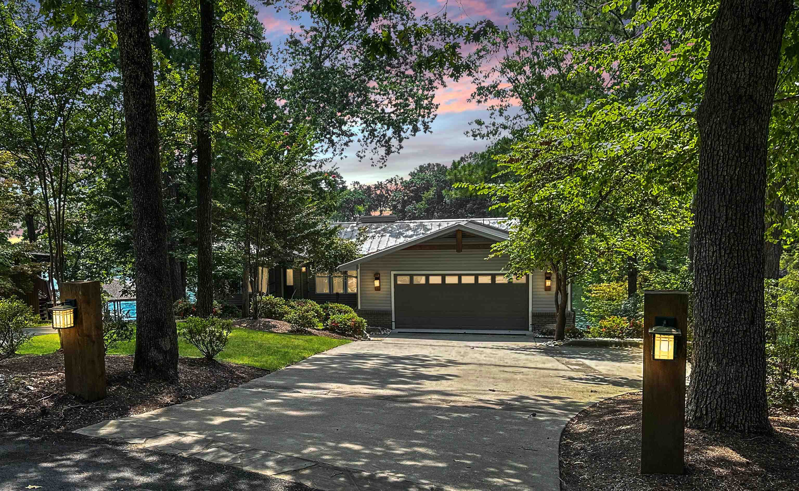 Welcome to lakeside luxury at its finest! Nestled in the prestigious Tanglewood Estates, this stunning 4-bedroom, 3-bath home sits on a prime cul-de-sac point lot, offering breathtaking panoramic views of Lake Hamilton. Step inside to discover an open, light-filled floor plan with walls of glass that frame the spectacular lake scenery. The main level boasts rich hardwood flooring, while the lower level features durable luxury vinyl plank flooring—perfect for easy lakeside living. Cozy up by the large wood-burning fireplace or entertain with ease on the expansive upper and lower decks, designed to maximize outdoor enjoyment. The kitchen and baths showcase beautiful maple cabinetry, adding warmth and elegance throughout the home. The double car garage and extended concrete driveway provide ample parking, with added convenience for utility vehicles to easily transport boating accessories to the water. Outside, you'll find lavish landscaping with meticulous rock scaping and French drains, enhancing both beauty and functionality. The double-stall covered boat dock includes hydraulic boat lifts and a swim dock, perfect for embracing the ultimate lake lifestyle.
