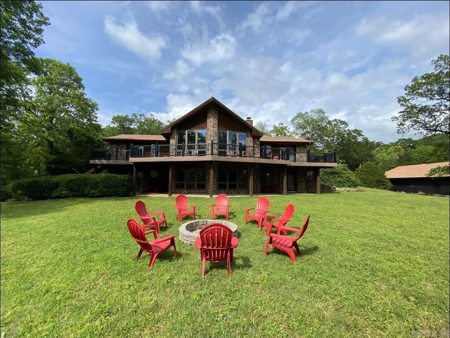 One-of-a-kind luxury lodge with 2 additional guest cabins and 2-slip floating dock sits on 10.34+/- riverfront acres, and features 300-feet of White River frontage near Flippin, Arkansas. 2-story main lodge features 4,700+/- Sq Ft, 4 bedrooms, 4.5 bathrooms, chefs kitchen with high-end Viking and SubZero built-in appliances, 2 stone fireplaces, and Terracotta tile and hardwood floors. Each bedroom offers a private bathroom and outside deck. The property comes fully-furnished... truly a turn-key investment!