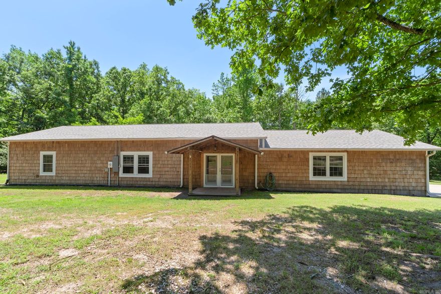 Enjoy the perfect blend of space, comfort, and country living with this 3-bedroom, 2-bath home on nearly 5 acres in the Bryant School District. The open floor plan seamlessly connects the living, dining, and kitchen areas—ideal for everyday living and entertaining. The spacious primary suite features a private en-suite bath and walk-in closet, while a secondary bedroom also offers its own en-suite and walk-in closet—perfect for guests or added privacy. A large garage provides ample space for vehicles, storage, or a workshop. Major updates include a new HVAC/heat pump (2021), roof (2024), electrical panel (2023), on-demand water heater (2021), new water lines (2021), and a 7,000-gallon septic system (2021). Additional highlights include a working well with Bison hand pump (2024), new spa (2024), and a termite inspection with transferable warranty completed 5/4/26. The property also features a second home site with all-new utilities and septic installed in 2021—ideal for future expansion, guest house, or rental potential. Enjoy peaceful country living with plenty of space to spread out. Buyers are encouraged to verify lot size using their own measurements.