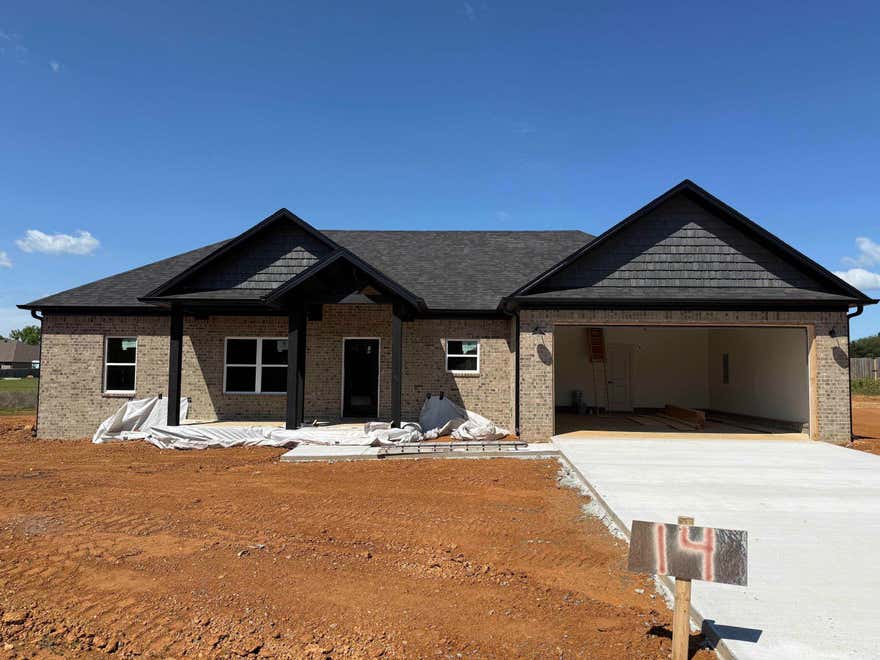 Brand-new construction offering modern comfort and timeless style! This thoughtfully designed home features an open-concept layout with a spacious living area, soaring vaulted ceilings, and abundant natural light. The kitchen is a standout with custom cabinetry, a large center island, and a walk-in pantry—perfect for everyday living and entertaining. A cozy fireplace anchors the living space, creating a warm and inviting atmosphere. The split floor plan provides privacy, while generously sized bedrooms and well-planned storage add functionality throughout. Step outside to enjoy peaceful views and a large backyard with endless potential for outdoor living. Quality craftsmanship, modern finishes, and a desirable layout make this a must-see property. Don’t miss your chance to own a beautiful new home in a serene setting!