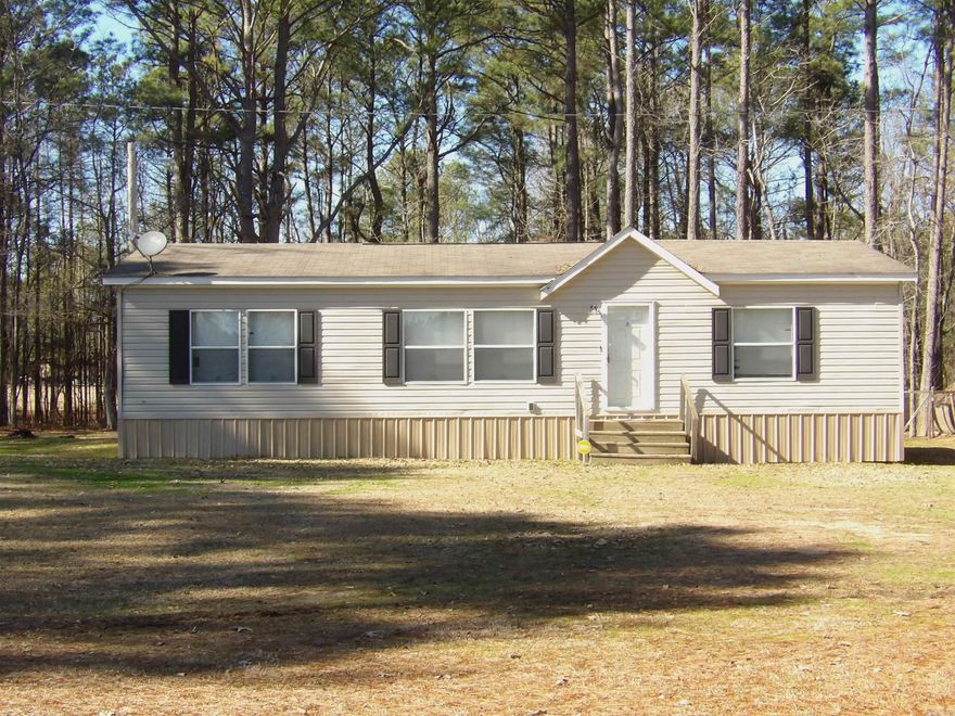 Priced below appraisal and ready to sell, as-is!  This adorable 3 bedroom, 2 bath, 2014 Clayton Mobile Home has 1404sf and approximately 6.43 acres. Open concept living, dining and kitchen. Spacious kitchen with abundant cabinet space, dishwasher and hook-up for electric stove. A wonderful island with pendant lighting and storage provides additional counter space and is connected to the dining room with built-in cabinets. Primary bedroom and bath with soaking tub and separate shower and walk-in closet, 2 additional bedrooms share a hall bath in this split floorplan. A nice covered deck on back will provide great space to relax. A chicken coop and storage building are also included. There is a creek that runs to a pond. Great space for the kids to play and ride 4-wheelers and bicycles! Call today for an appointment to see this property.