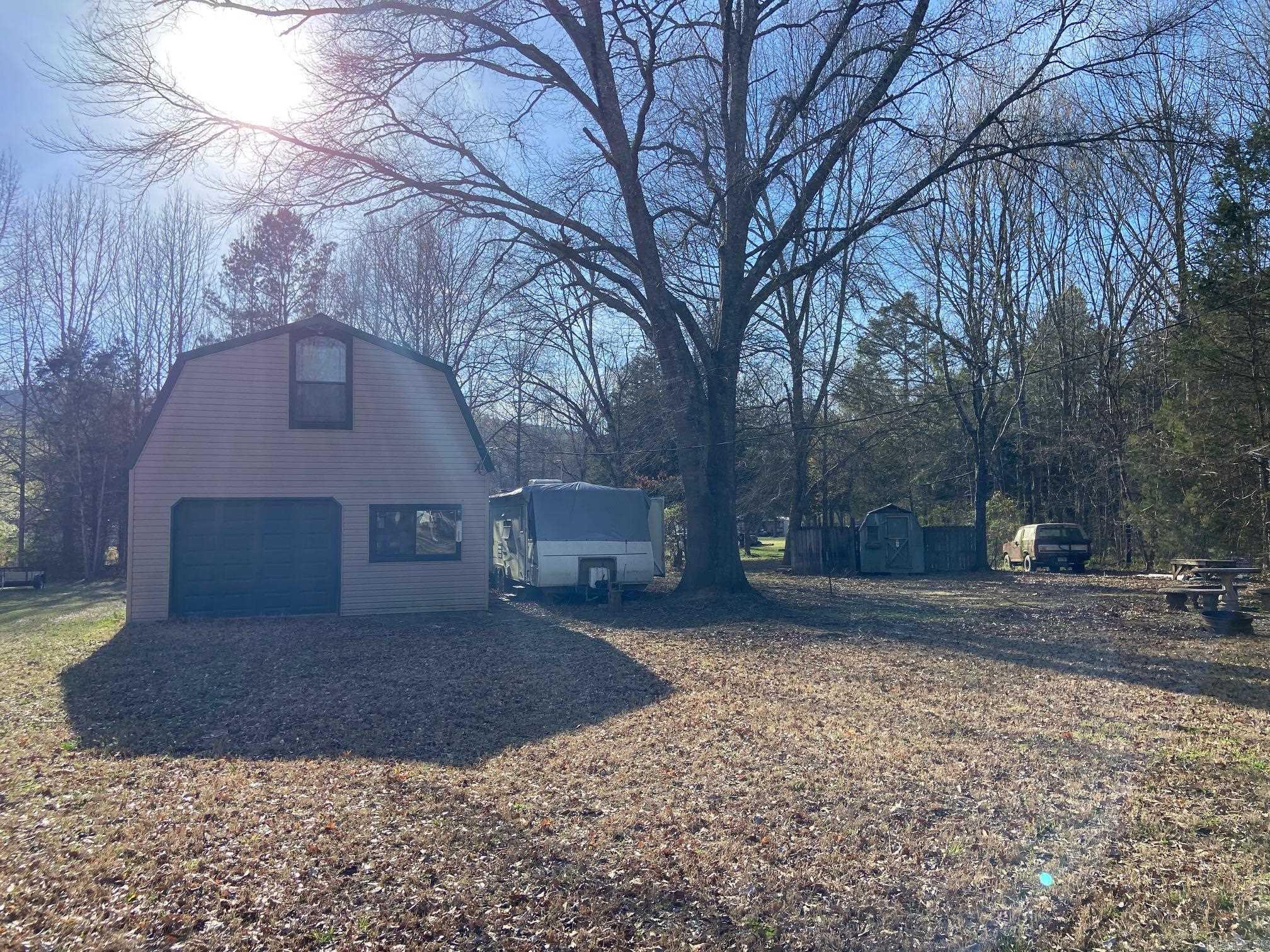 This has been a fishermans cabin in progress, located across street from the little red river. All building material in home goes with the property. There is a half bath upstairs but it is not finished. It has great tiny home potential. Home and camper on the property is staying in as is condition. There is a second camper hook up on the right side of property. The Tractor/lawn mower, Bronco and the canoe do not stay with the property. All appliances stay in as is condition.