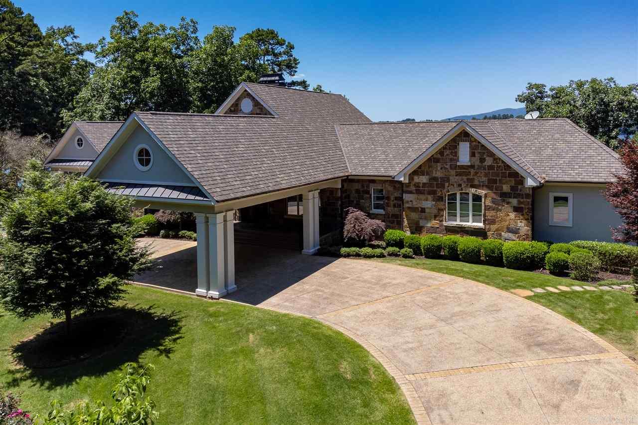 Lake life at it's finest! Updated in 2019, this gorgeous home boasts 3 living areas plus an office, gourmet kitchen and 2 wet bars. The exterior features large pool, cascading fountain and 2 fixed covered boat slips. Magnificent inside and out. Spectacular views of the main channel 150 feet of lake frontage. Appointment only. Cannot be shown until June 15.