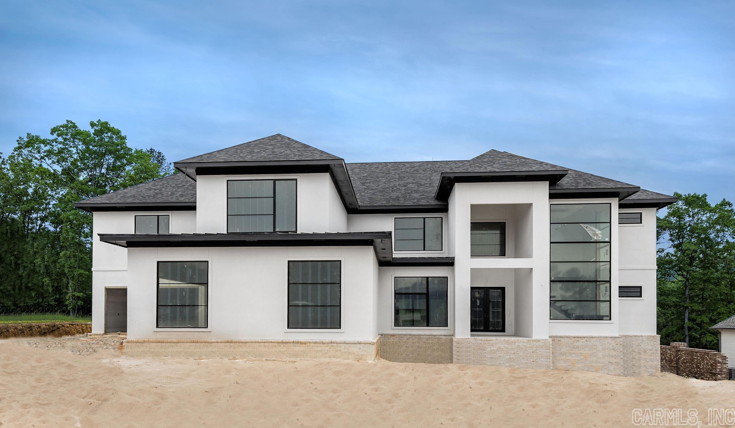 This stunning new build can be found in the gated neighborhood of Orle and offers golf cart access to the Chenal Country Club. Construction is expected to be completed this summer so if you are looking for a 5 bedroom home, all with private bathrooms this could be the home for you. Floor to ceiling windows are the setting for the homes stunning floating staircase at the entry. The open great room and kitchen feature a wall of panoramic doors, a gateway to indoor-outdoor living. The design details don’t disappoint in the primary suite on the main level of the home, with a sitting area, spa bath and oversized walk-in shower. And if you love closets, this one is amazing! Need an office or work-out room? There is a flexible space downstairs in the home that can be used as you wish but certainly spacious enough to accommodate a home office or gym! Also on the main level of the home is the second bedroom with an ensuite bath. The other three bedrooms with ensuite baths are located upstairs along with a media room complete with its own wet bar. Also upstairs is an oversized landing for additional living space and an additional flexible room. Amazing!