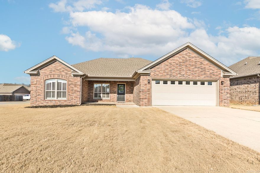 Pretty brick home offers 3 bedrooms, 2 baths, 1766 sq ft, 2 car garage, situated on a big corner lot.  Living room has wood flooring, gas fireplace, tray ceiling, recessed lighting, office area or formal dining space.  The kitchen has stained cabinets, breakfast bar, granite countertops, pantry cabinet with roll outs, refrigerator stays!   Large laundry room.  The master bedroom is apart from the other 2, master bathroom has 2 sinks, separate tub and shower, large walk-in closet.  All new carpet in bedrooms, custom plantation blinds throughout the home.  Large fenced in back yard with double gate on the side.