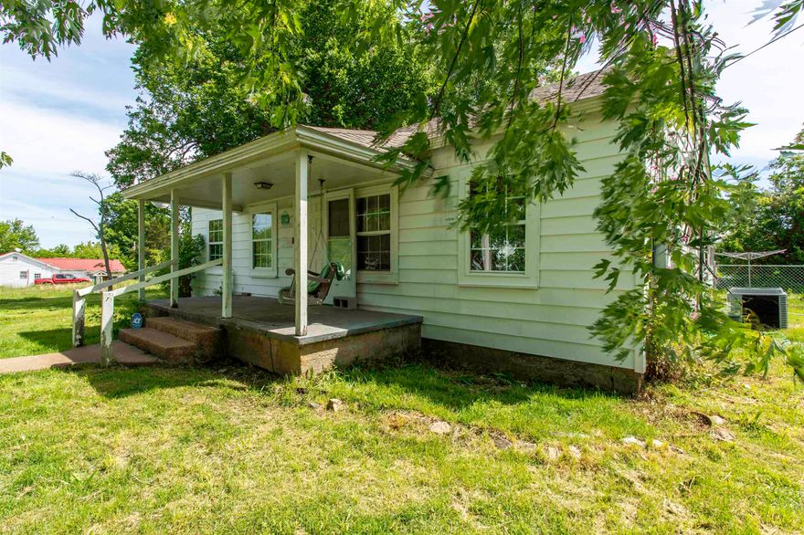 **Country Charm with Shop, Fenced Yard & Shaded Lot**  Full of character and country charm, this craftsman-style home 1,296 sf sits on a beautiful shaded lot in Oxford, Arkansas. From the covered front porch with a porch swing to the old-style wood panel doors inside, warm, welcoming feel the moment you arrive.  The home features a nice sun porch, a screened-in patio in the backyard for outdoor entertaining, and a chain-link fenced backyard that offers great space for pets, kids, or gardening. A 24x24 red iron shop building with 100-amp service provides plenty of room for storage, hobbies, tools, or workspace.  This property has also seen many important updates in the last few years, including most windows updated to vinyl, roof replacement in April 2020, heat pump and ductwork installed in Dec 2020, incoming plumbing replaced with PEX in spring 2021, and fencing installed in spring 2021. Additional updates include new crawlspace bracing in Aug 2023, kitchen windows replaced in 2023, stove replaced in April 2020, dishwasher in 2024, and refrigerator new in 2024.  A home with practical updates, outdoor living space, and a great shop—this one offers the best of country living.