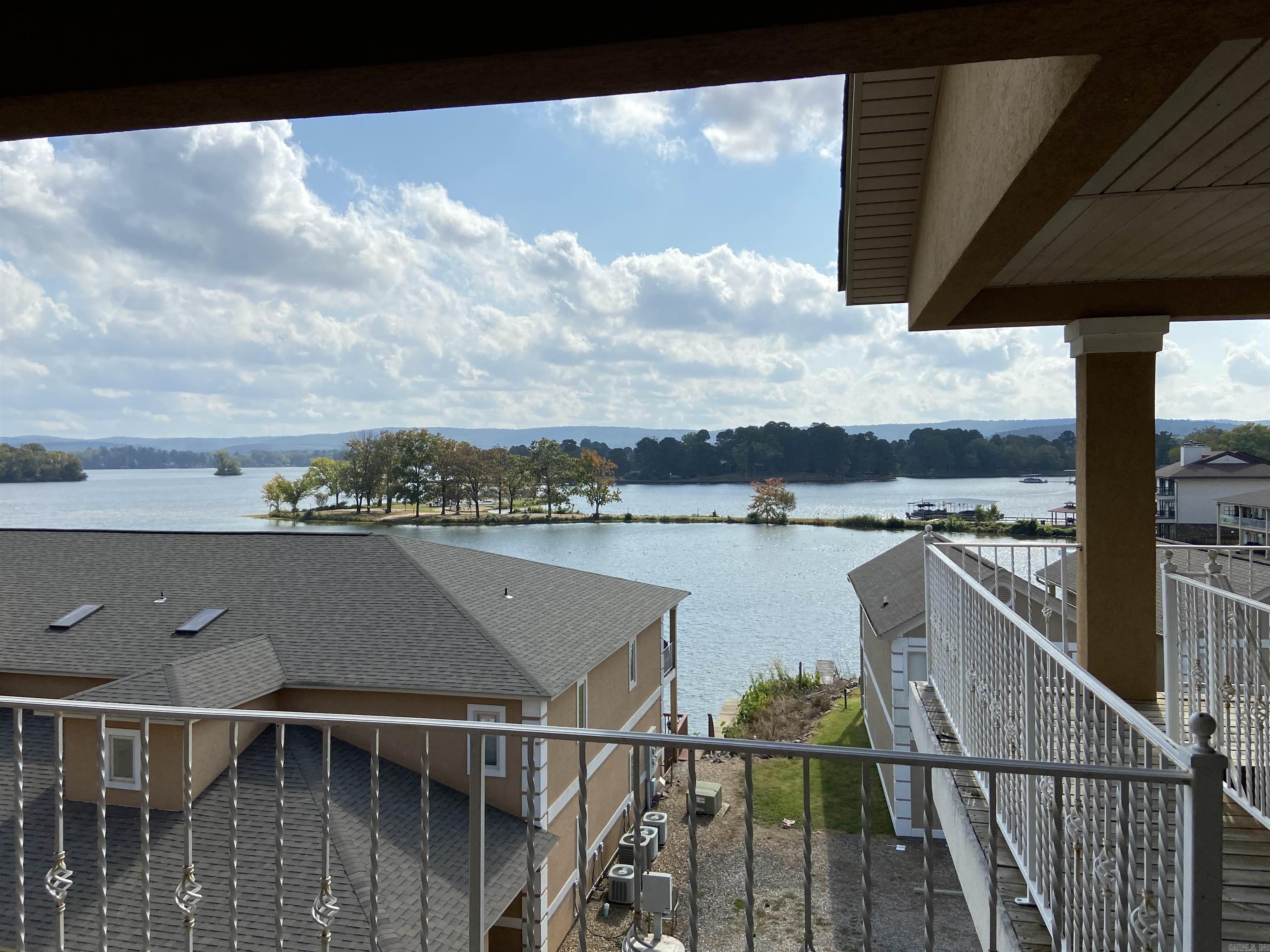 Don’t miss this wonderful 2 bedroom 2 bath corner condo overlooking Lake Hamilton. This condo is located in the coveted 7 South area close to everything. This home offers an open floor plan with vaulted ceilings a fireplace and French doors opening up to the large deck. The primary suite has double vanities a walk in shower and a jacuzzi tub! It also has access to the deck through the French doors. There is a fire pit to be enjoyed by all residents and a community boat tie up. Nightly rentals are allowed.