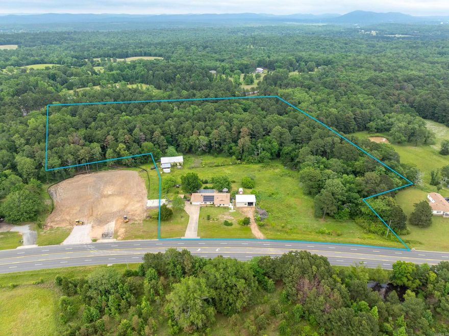 10.37 Acres with a brick house and 2 barns. The house is brick and has good bones, there is a 40X60 pole shed. There is a pool behind the house, needs new liner or can be filled. Can be sold either commercial or residential. There is a Dollar General going in next door and the school is close by will have a lot of visibility for any kind of business or easy access to a main corridor.