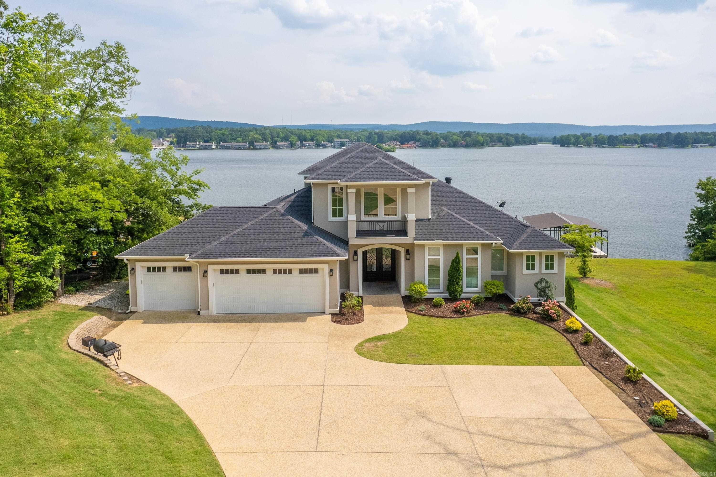 Must see this stunning 5 Bedroom 4 Bath Lake Home that has some of the biggest views on Lake Hamilton. The exterior boasts a large lot, three car garage, covered patio, a pool over looking the main channel, new 2 stall boat dock, and much more. The interior includes open concept kitchen/dining/living, two bedrooms on the main level, a beautiful kitchen, and a large primary en suite. Investors take notice as this is currently one of the most successful short term rental properties on Lake Hamilton. Great investment opportunity or perfect lake home for your family. This property is being sold fully furnished, turn key opportunity.