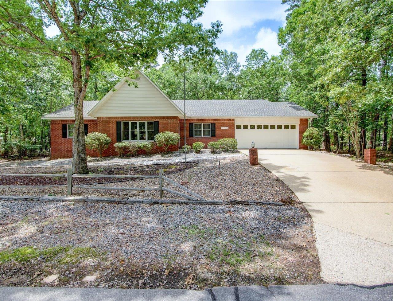 CHARMING VILLAGE RETREAT! This cozy 3 bed, 2.5 bath home has a BRAND NEW ROOF, wooded lot, and is just minutes from the Coronado Center, Woodlands Auditorium, POA, hiking trails, golf courses, pickleball/tennis courts, and lakes. Inside is an open floor plan where the living room, with tray ceilings and fireplace, flows into the dining area - ideal for hosting gatherings. The bright sunroom off the dining space offers serene wooded views, making it the perfect spot for a home office, creative haven, or simply unwinding in the surrounding beauty. The spacious kitchen has ample cabinet and storage space, an eat-in area, and a breakfast bar. Double doors lead to the generous master suite, complete with a walk-in shower, dual vanities, and a large walk-in closet. The large laundry area has a half bath. Outside there's a patio, where mature trees provide dappled shade and create a tranquil setting for morning coffee or evening relaxation. There's also an attached two-car garage and extended side driveway - perfect for your golf cart. Roof comes with 5 year transferable warranty, on labor, to the new owner. Agents: Please schedule all showings through the Showing Service.
