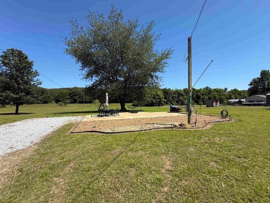Located in the Sylamore area, this 15-acre property offers excellent access with frontage on North River View Lane and additional blacktop road frontage along the southern boundary. The land is level and usable, making it ideal for a variety of residential, recreational, or development opportunities. The property is already equipped with a well-prepared RV setup, including a concrete pad, electrical and water hookups, septic system, and an outdoor cooking area. It’s a great setup for trail riders or outdoor enthusiasts—bring your horses and enjoy turning them out on the open pasture while staying comfortably on-site. Conveniently located just across the river from Angler’s Restaurant at Slyamore and Allison, this property places you in the heart of one of North Central Arkansas’s most sought-after recreational areas. You’re only a short drive from Mountain View, the Ozark Folk Center, Blanchard Springs Caverns, and the Ozark National Forest. With level terrain and available utilities, this property presents excellent potential for development, all for only $190,000.