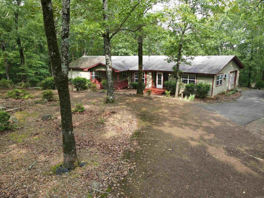 This home sets on .90 acres surrounded by woods. A winter view overlooking the lake.  Circle driveway adds to the parking. HVAC is only a few years old, new paint, dual hot water heaters, house generator. Two bedrooms on main level with baths.  One bedroom downstairs with bath.  Screened Porch, Sunroom, Room for office, crafts or exercise.  Extra family room.  This home is waiting for you!