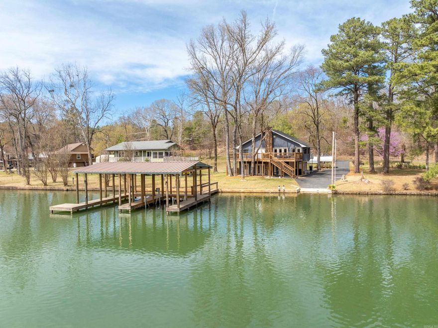 This unique lake property will surprise you w/ the extras. Entry level of the 1,626 sq ft main house you'll find a large great room w/ 1/2 bath, fireplace & full view glass doors, allowing a lovely view & easy access to lake. Upstairs has 2 beds, 2 baths, office/entryway, kitchen, pantry, & living & dining areas w/ same glass doors for an even better view! New fabulous deck, that overlooks Lake Hamilton & wraps around the house, leading you to 576 sq ft studio apartment w/ kitchenette & bath, above a 2 car garage. Plenty of parking on this level lot w/ additional 1 car garage & carport. Very nice exterior lift & ramps have been added for handicap accessibility. Part of yard under deck is fully fenced, allowing pets to come in & out through the pet door & safely play outside. Upgraded Leaf Guard gutters & both new roof & siding within last 2 yrs. Home & apartment completely remodeled within last 5 yrs including new water heater, security system, & refinished driveway. High Speed internet available. City water & well. Approx. 90 ft lakefront. Recently widened boat ramp & new 2 slip, covered boat dock w/ lift. Sleeps 12 w/ current furnishings. Fantastic family home OR rental property!