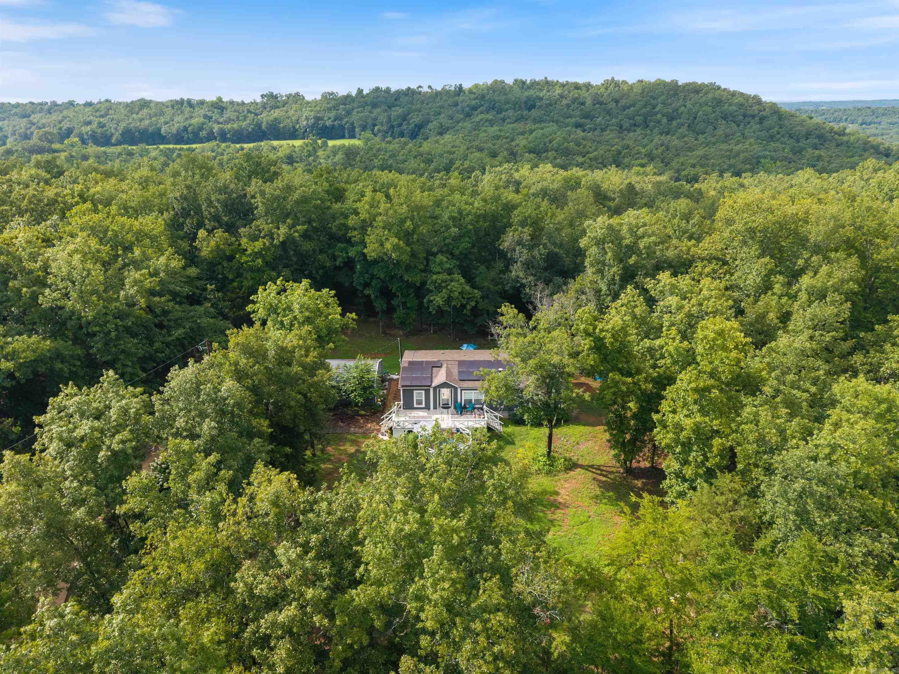 Secluded and tucked away down a long, winding driveway is 29 Stoney Dr. This rare opportunity to purchase your peaceful retreat won't be available for long. +/- 33 acres of beautiful trees and freely roaming wildlife offer privacy and a relaxing natural setting. Certified Energy Smart 3 bedroom, 2 bath is an energy efficient home and INCLUDES solar panels that have been paid off! This beautiful open floor plan boasts a fireplace, large kitchen with immense storage, large primary bedroom and ensuite has his and her sinks and a large walk-in shower and a separate laundry room with extra storage room. This property invites you to unwind, breathe deep & stay awhile. Do you like parks and lakes to fish? This property is around 15 mins to Beaver Fork Lake and 10 mins to Matthews Park. AGENTS: Please see remarks. Refrigerator, washer & dryer to convey with acceptable offer.
