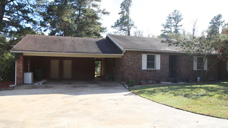 This lovely rustic home, located on just less than 10 acres, is conveniently placed 6 miles outside the city limits of Magnolia.  This 3 bedroom, 2 bath home has great space inside to make it your own.  It has a well sized, fenced in back yard, as well as a two car garage with a storage room.  This property has a 900 square foot shop and a rental house beside it.  This property has 3 excellent ponds and great timber.  The second house has a tenant in it at the moment.  He is willing to move out or continue paying rent if the new buyer wants to allow him to stay.  Rent at the moment is $500 a month.  Tenant also mows and weed eats the yard for the entire property.