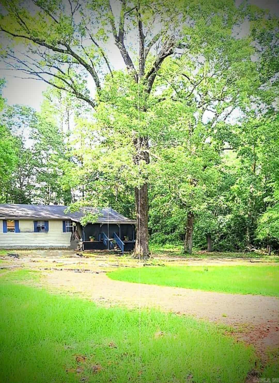 undisclosed address, live video surveillance, sits adjacent to White Oak Lake State Park, recently renovated as hunting lodge on Airbnb, flue installed through roof in main room for wood burning stove, updated paint throughout, brand new modern interior doors with privacy locks, new flooring in bedrooms, whole home weatherization updated, floors/walls air sealed, extra insulation added, water pipes wrapped, 2nd bathroom currently unfinished & used as storage room. Imported Mexican Talaver tile flooring in kitchen, dining, hall, master bedroom, 6x8 rear utility room could use new linoleum. 2nd layer of shingles added in 2022. Over $50k in mature saw timber with easy access & intact barn over 150 yrs old with valuable pieces of aged lumber. Furnished, as is, priced to move.