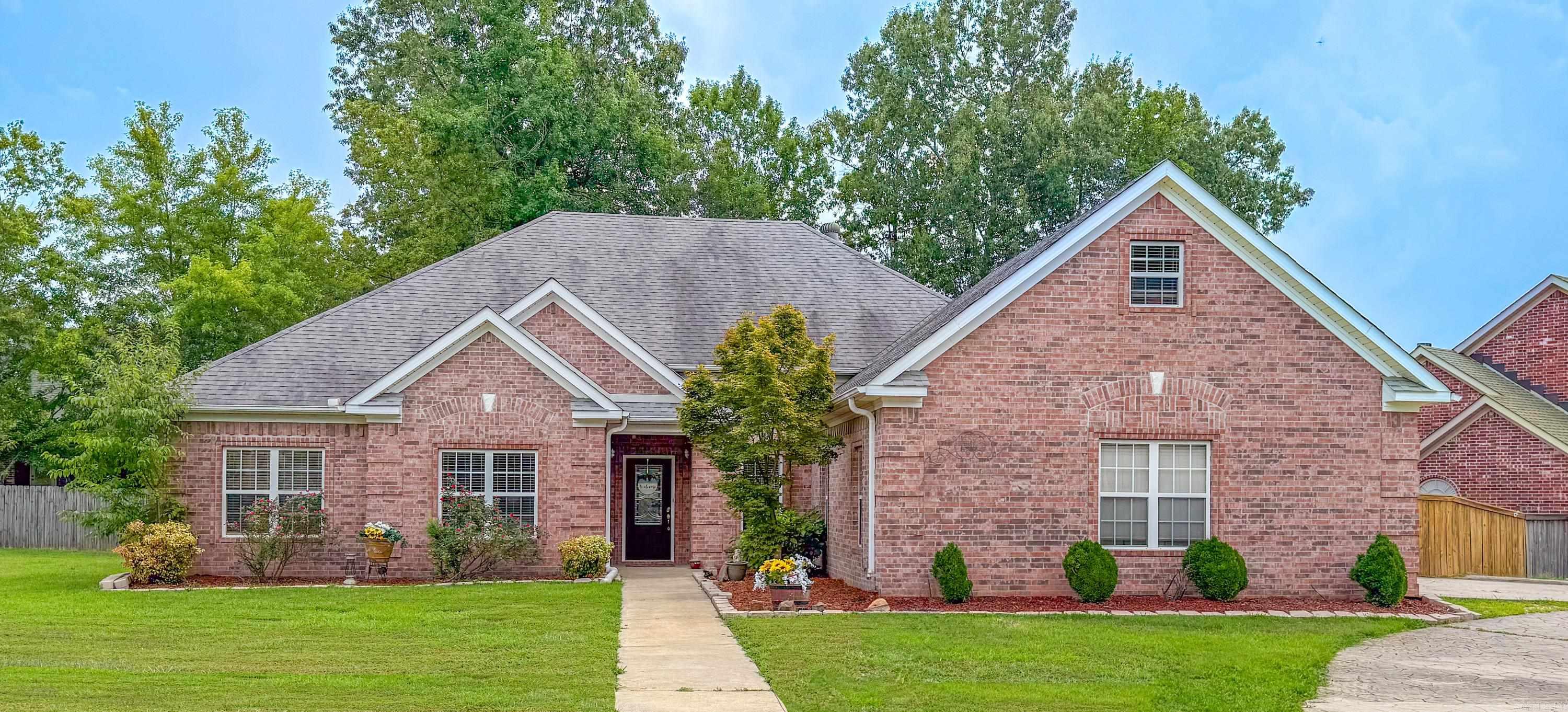 This all-brick home blends comfort and charm with thoughtful updates throughout. The living room features coffered ceilings and a wood-burning fireplace with a gas starter, creating a warm and inviting space. New LVT flooring runs through the main living areas, and the kitchen boasts a large walk-in pantry. Enjoy year-round use of the heated and cooled sunroom. The oversized primary suite includes a sitting area, walk-in closet, jetted tub, and walk-in shower. A fourth bedroom and third full bath are set apartāideal for guests or multigenerational living. The laundry room is spacious, and the double garage includes an electric attic lift for easy storage. HVAC replaced in 2023. A dry creek adds natural charm to the backyard. Ample Parking with Large stamped concrete circle drive and parking pads. Access to pickleball, pool, clubhouse, and more! Agents see remarks.