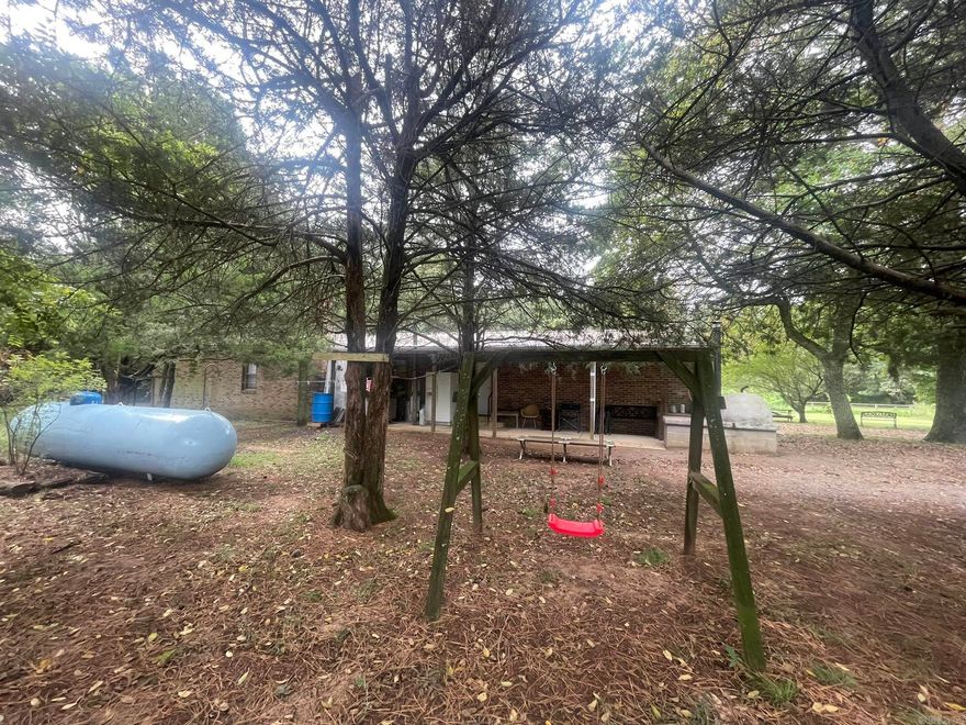 A country home in a quiet, peaceful setting with plenty of space for gardening, livestock or just enjoying the wildlife. The home is very clean with an Amish Stove, outside pizza oven, many storage buildings, a chicken coop and a man-made storm cellar. Agents, please see remarks.