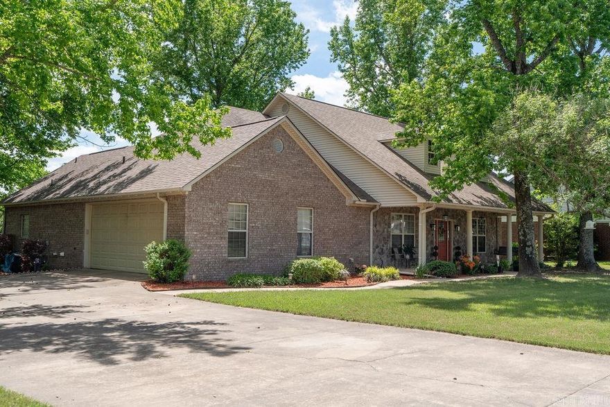 Located in the heart of Vilonia, this beautiful 3 bedroom, 2 bath brick and stone home offers 2,148 sq ft of well-designed living space perfect for both everyday living and entertaining. The open-concept layout seamlessly connects the spacious living room, dining area, and kitchen, creating a welcoming atmosphere, while the split floor plan provides privacy for all. The primary suite features a private ensuite with a soaking tub, extra cabinetry, and an incredible walk-in closet with custom built-ins, plus direct access to the covered back porch. A private office offers flexibility and can easily serve as a formal dining room or fourth bedroom. Recent updates include new kitchen countertops, backsplash, sink, fixtures, LVP flooring, accent lighting, and an updated guest bathroom. The oversized garage includes workspace, room for toys, and a built-in safe room. Enjoy surround sound throughout the living room, kitchen, primary suite, and back porch, along with an above-ground pool, beautifully landscaped yard, and a charming front porch swing. Roof replaced in 2018.