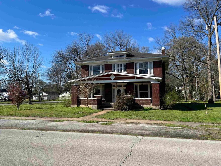 Step into the charm of 1926 craftsmanship. This spacious two-story Craftsman offers approximately 3,388 square feet with 5 bedrooms and 2 full baths. Filled with historic character and original architectural details. Inside you’ll find hardwood floors, tall ceilings, vintage trim, French doors, and large windows that bring in beautiful natural light throughout the home. A striking wood-burning stove fireplace with an ornate built-in mantel anchors the main living area, while the layout includes a formal living room, separate dining room, bonus space, and an upstairs landing that adds flexibility. Sitting on a corner lot of approximately .49 acres, the property also features a brick exterior and covered front porch that reflect the home’s classic design. Homes of this size and era are becoming increasingly rare, offering an opportunity to restore and personalize a historic Newport property while preserving its timeless character. Property offered in its present condition.