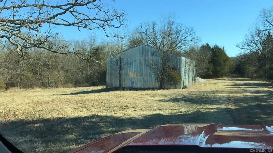 13.185 Surveyed Acres in Timber Shoals Ranch – Lake Access, Wildlife, and Endless Possibilities  Discover the perfect blend of seclusion and recreation with this 13.185 surveyed-acre parcel nestled in the heart of Timber Shoals Ranch. This mostly wooded tract features mature hardwoods throughout and includes a small clearing—ideal for building your dream cabin, weekend getaway, or forever home.   A portion of the property borders Bull Shoals Lake Corps land, offering direct and easy access to the lake for fishing, boating, and water adventures. There's a barn/shed on-site—perfect for storing your boat, tractor, or outdoor gear.  Electricity is available nearby, and the land lays well for building or exploring. Nature lovers and outdoor enthusiasts will appreciate the abundance of wildlife, including whitetail deer, turkey, bear, and small game—making it a hunter’s paradise or a serene spot for wildlife watching.  Located approximately 36 miles from Branson, you’re close enough for shopping, dining, and entertainment, yet far enough to enjoy the quiet beauty of the Ozarks.  Come experience peace, privacy, and the natural charm in the heart of the Ozarks!!!