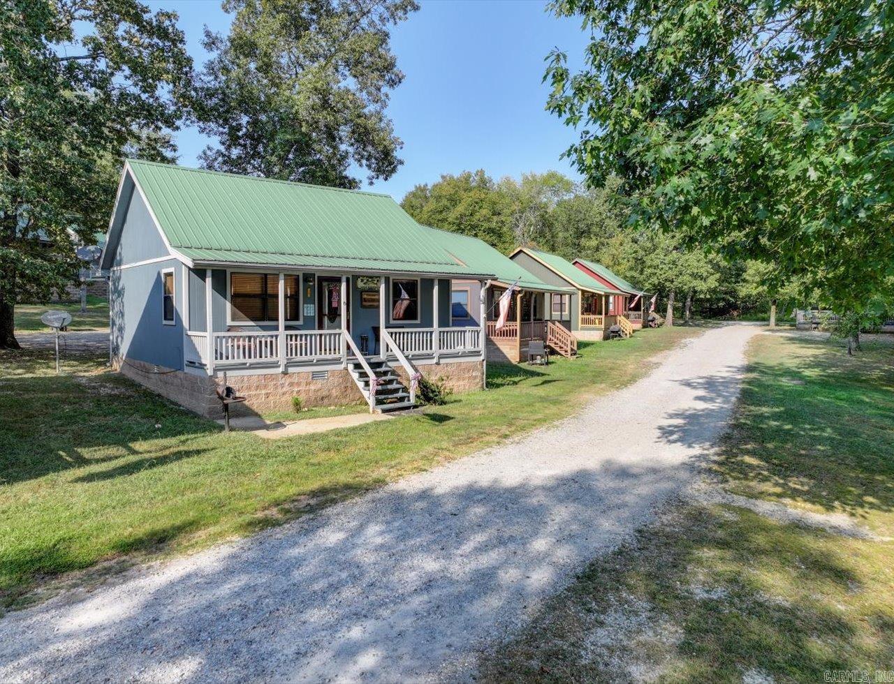 **Cozy Cottage Retreat on Lake Hamilton!** Welcome to your lakeside escape! This adorable, fully furnished cottage is nestled in a quiet community on Lake Hamilton, offering the perfect blend of charm and relaxation. With 2 bedrooms and 1 bath, the cozy retreat is move-in ready and ideal for a weekend getaway or a full-time residence. Enjoy stunning lake views from your own piece of paradise. Whether you love fishing, boating, or simply soaking in the serene surroundings, this location has it all. The property includes a boat dock and a private boat launch, making it easy to get out on the water whenever you like. Short-term rental allowed. Agents - Call Showing service to schedule all showings.