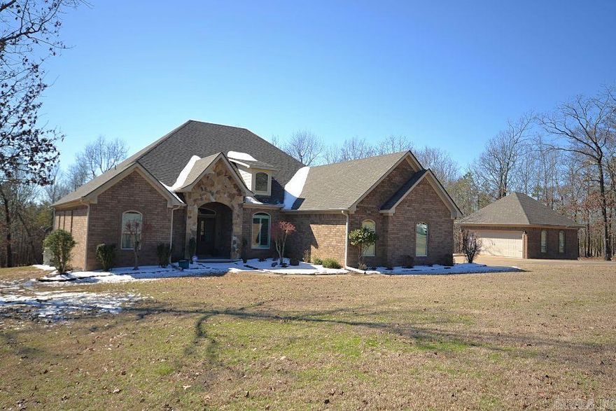 Exceptionally Maintained One-Level Home on Nearly 3 Acres! Enjoy the perfect blend of serene country living and the comfort of a welcoming neighborhood in this beautifully maintained, one-level home. From the moment you step inside, you’ll be captivated by the rich hardwood floors, soaring ceilings, and elegant deep crown moldings. The open floor plan and stunning kitchen set the stage for effortless living and entertaining. Outside, the amenities continue with a screened porch, a spacious pavilion featuring a massive stone fireplace—ideal for outdoor gatherings—and a detached two-car garage/workshop in addition to the three-car garage. Located in a gated neighborhood, this home boasts numerous updates, including a new roof, new HVAC, upgraded showers, plantation shutters, new pavilion posts, and barn doors in the bedrooms. A brand-new water line to the street ensures peace of mind. Don’t miss this rare opportunity—schedule your showing today!