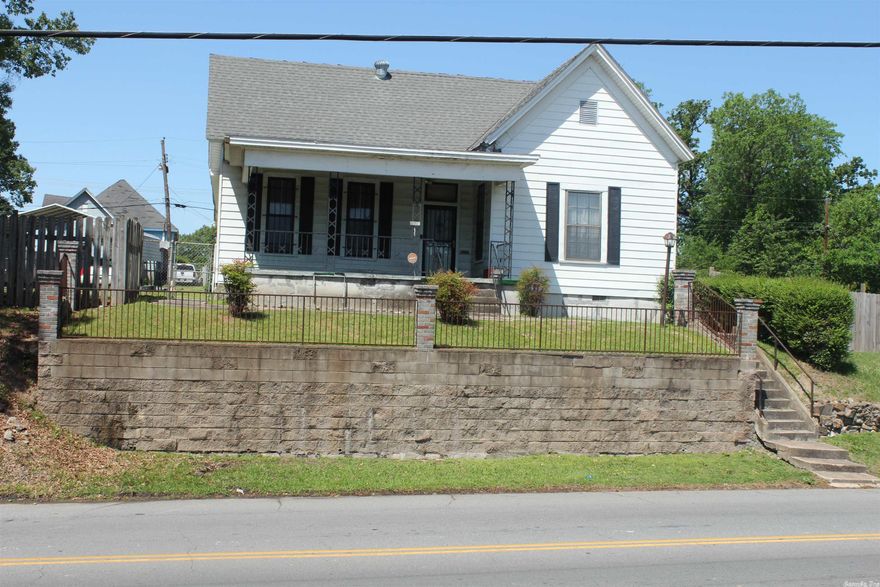 3 BR 1.5 Bath starter home or investment property with large rooms, separate dining and living room. Fully fenced yard, w/alley access plus carport situated on 2 lots. Home is being sold As-Is.