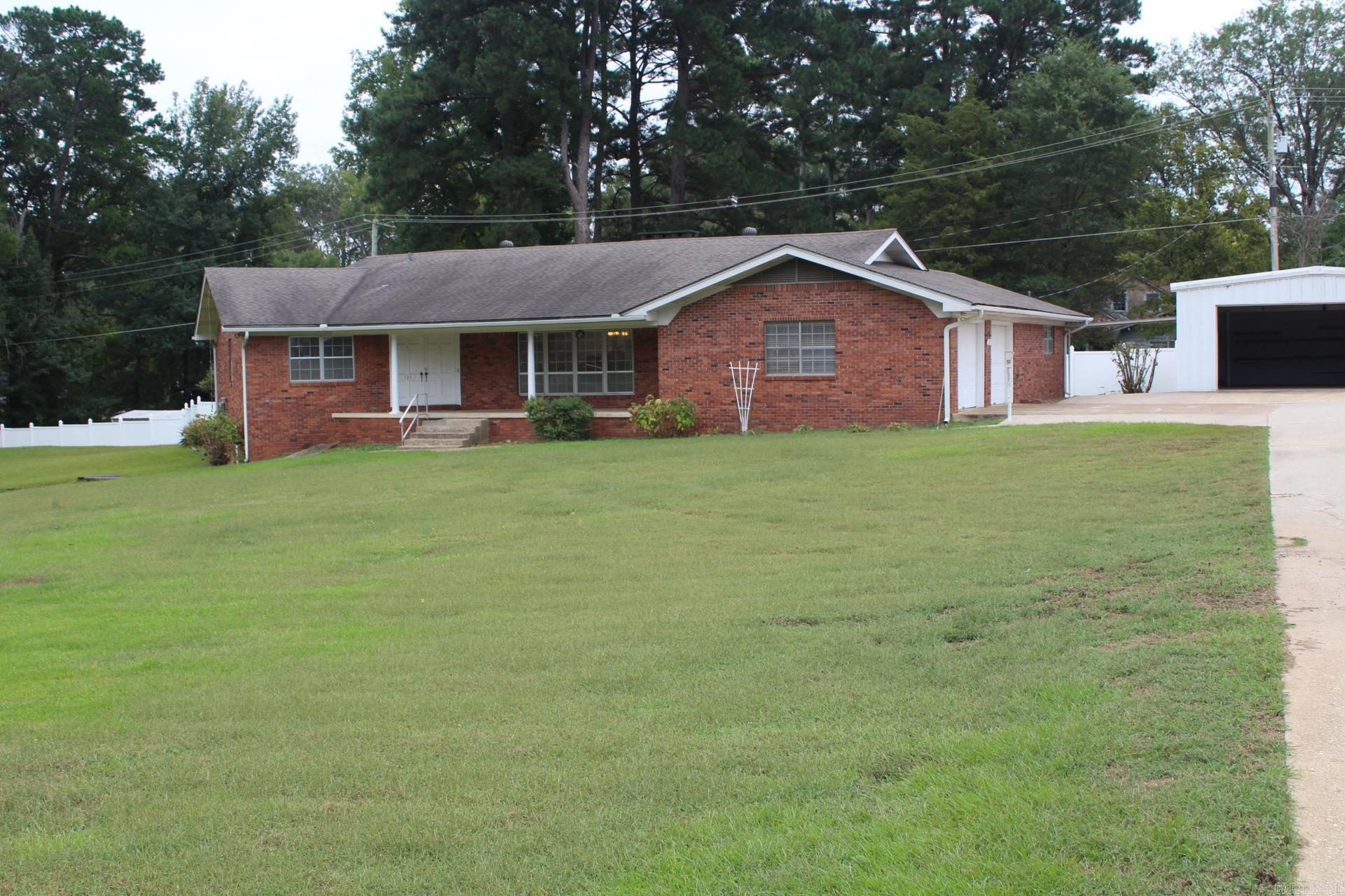 3 Bedroom, 2.5 Baths with approx. 2688 Sq. Ft. of living space located in the heart of Nashville situated on a approx. 1 acre lot. Large kitchen with the electric range, refrigerator, dishwasher conveying with sell of home. Family area features massive brick fireplace & beamed ceiling. Home has knotty pine walls & ceilings. Central A/C & Heat. Covered patio. Home has a basement storm shelter. Property has a 24 x 30 shop (garage) and white vinyl fencing.