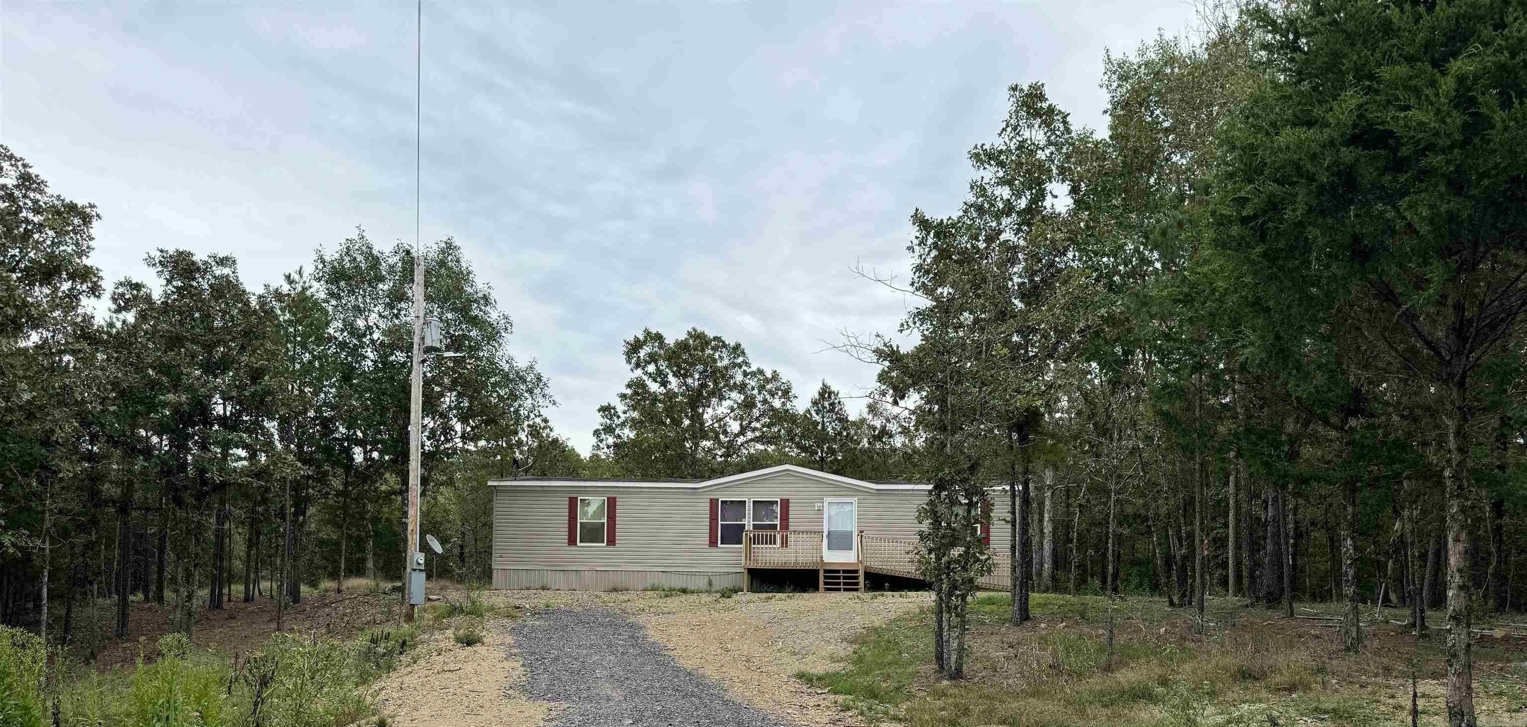 This 3.5 acre surveyed property features a 2023 Champion double wide that is 3 bedrooms and 2 bathrooms with a spacious 1560 sq ft living area. NO RESTRICTIONS. Wheelchair accessible. NEWLY mulched backyard with plenty of woods left for your privacy. There is a wet weather creek on the property. Current termite policy. Less than 1 mile to national forest. If you are looking for privacy and seclusion, this is the one! Agents see remarks.