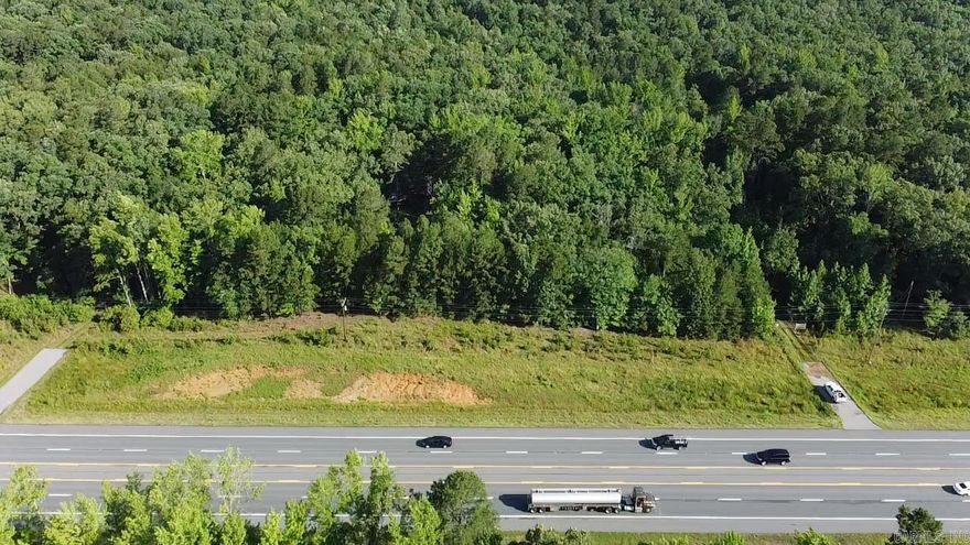 Location, location, location. It is situated between Benton and Hotsprings on Highway 70, but there is enough land to build back off the road. The timbered property with openings could be a great hobby farm or hunting property. The property does need a little cleanup, love, and TLC, but it is a great property in a great location. There are a lot of really big oak trees. The terrain is beautiful, rolling up to a buildable area. Water and electricity are available.