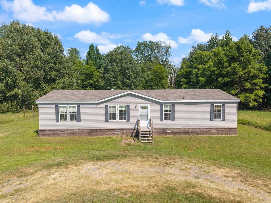 This modular home sits on 5 acres outside the city limits. Opportunity to fix up and enjoy the privacy of acreage while still being a short distance to I-40. Pier and beam foundation. Back portion of the property includes wetland acreage with duck hunting potential. Located in the 100-year floodplain of the Arkansas River. Cash or conventional financing only. Sold As-Is. ***Agents See Remarks***