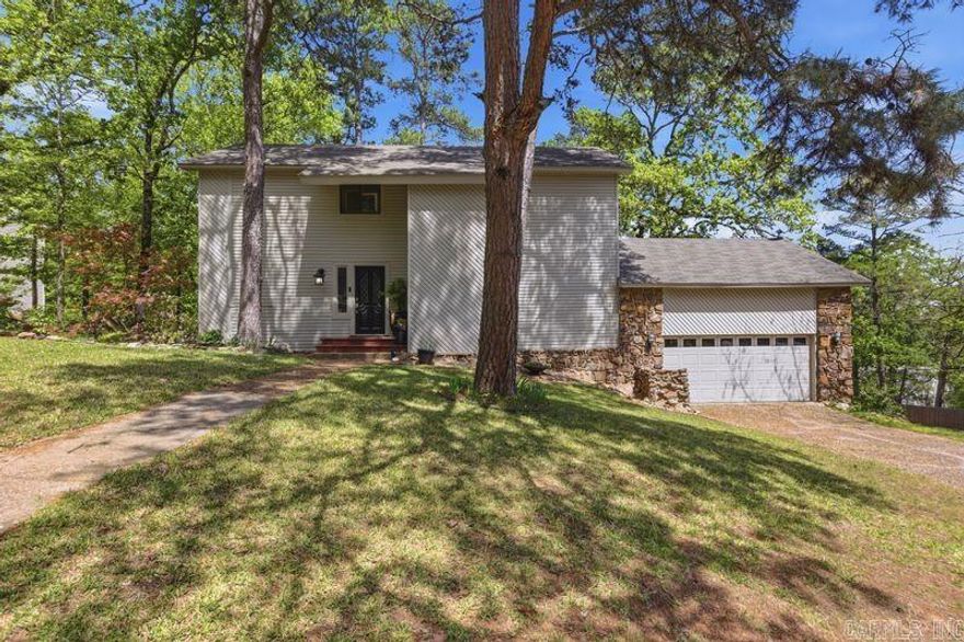 Take a tour through this thoughtfully updated home situated on a large, private corner lot in the heart of Maumelle. This property has been updated from top to bottom with purposeful attention to detail and offers a functional layout. Major system upgrades include: Roof replaced in 2018, new Heat and Air installed in November 2025, a new Water Heater in 2024, Electrical Panel replaced 2023, Skylight replaced 2026, and New Fireplace 2026. The main living area features a vaulted ceiling, floor-to-ceiling stone fireplace, skylight, and a loft area overlooking the space—perfect for a sitting area, home office, or kids’ play area. The updated kitchen includes granite countertops, updated appliances, new lighting, tile flooring, a mobile island, and a water filtration system. Under-staircase storage adds extra functionality. The primary bedroom is located on the main level and includes an updated en-suite bathroom and walkout access to the back deck. Upstairs offers two guest bedrooms and a hallway bathroom featuring a jetted whirlpool tub and additional storage. Outside, enjoy the privacy of the fully fenced yard and the convenience of a two-car garage.