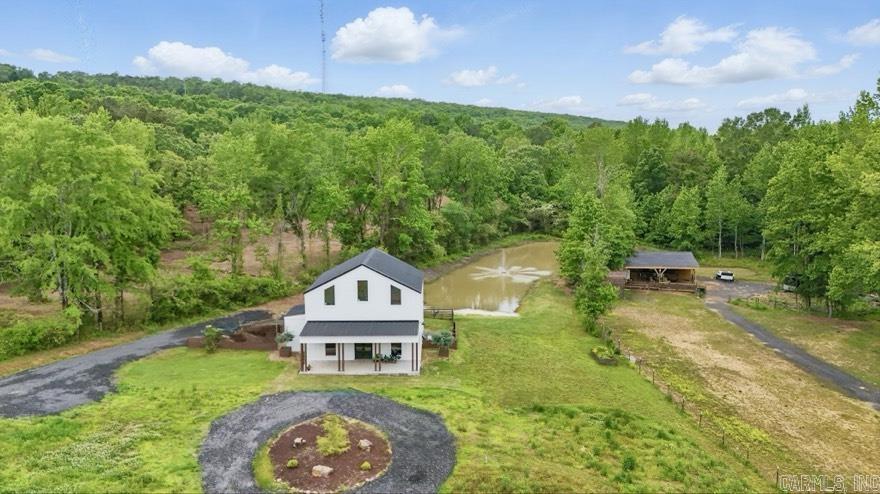 Welcome to 3625 Mountain Springs Rd. – a custom-built 2022 home on 12.07 scenic acres in Cabot’s desirable Greystone area. This 1,923 sq.ft., 4-bedroom, 2 bathroom 2-story home features soaring 12’ ceilings, 8’ doors, and high-end framing and foundation structural design by a licensed engineer. A flexible utility room offers the option for a 5th bedroom or home office. Enjoy peaceful outdoor living with multiple ponds, creeks, mature hardwoods, and a barn with stables, and trails. The property itself is tucked away outside city limits in the county for added privacy and freedom, yet close to everything including the sought after neighboring Mountain Springs Elementary. Rare opportunity to own a modern, unique home in a great location!