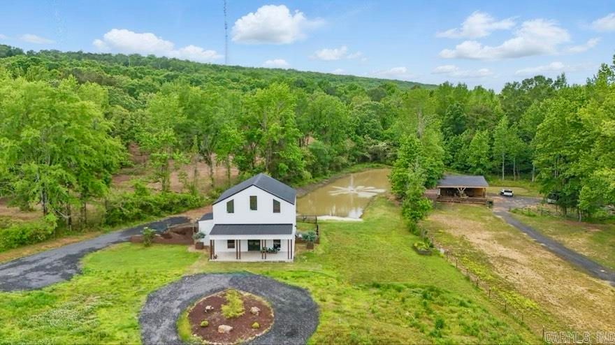 Welcome to 3625 Mountain Springs Rd. – a custom-built 2022 home on 12.07 scenic acres in Cabot’s desirable Greystone area. This 1,923 sq.ft., 4-bedroom, 2 bathroom 2-story home features soaring 12’ ceilings, 8’ doors, and high-end framing and foundation structural design by a licensed engineer. A flexible utility room offers the option for a 5th bedroom or home office. Enjoy peaceful outdoor living with multiple ponds, creeks, mature hardwoods, and a barn with stables, and trails.  The property itself is tucked away outside city limits in the county for added privacy and freedom, yet close to everything including the sought after neighboring Mountain Springs Elementary. Rare opportunity to own a modern, unique home in a great location!
