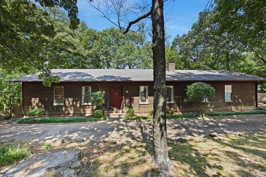 Experience breathtaking vistas from the bluff of Skyline Drive, offering panoramic views of Russellville. This stunning home boasts two spacious living areas, an upper deck, and a lower screened area, all showcasing the beautiful surroundings. The main level features a massive master suite alongside two bedrooms, while the downstairs living space includes an additional living area. Whether in the kitchen, living room, or master suite, the views from every corner of the home are truly mesmerizing.