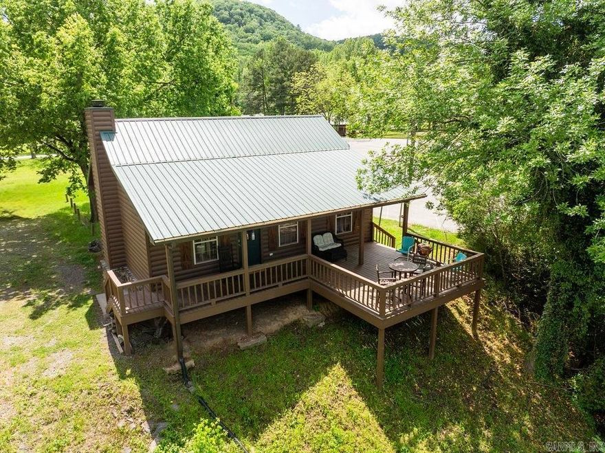 Escape to your perfect riverside retreat at Lobo Landing Resort on the scenic Little Red River. This fully furnished log cabin offers 2 bedrooms and 1 bath with blends of rustic charm and modern comfort, featuring updated décor, a cozy wood-burning fireplace, and an open living, dining, and kitchen area. Relax on the spacious, partially covered deck with peaceful river views. Just steps from the marina and next to a public boat launch, it's ideal for boating and fishing. Located in a renowned trout fishing area, this cabin is perfect for outdoor enthusiasts and an excellent getaway spot. Great area for a short term rental if you are looking for an investment opportunity.