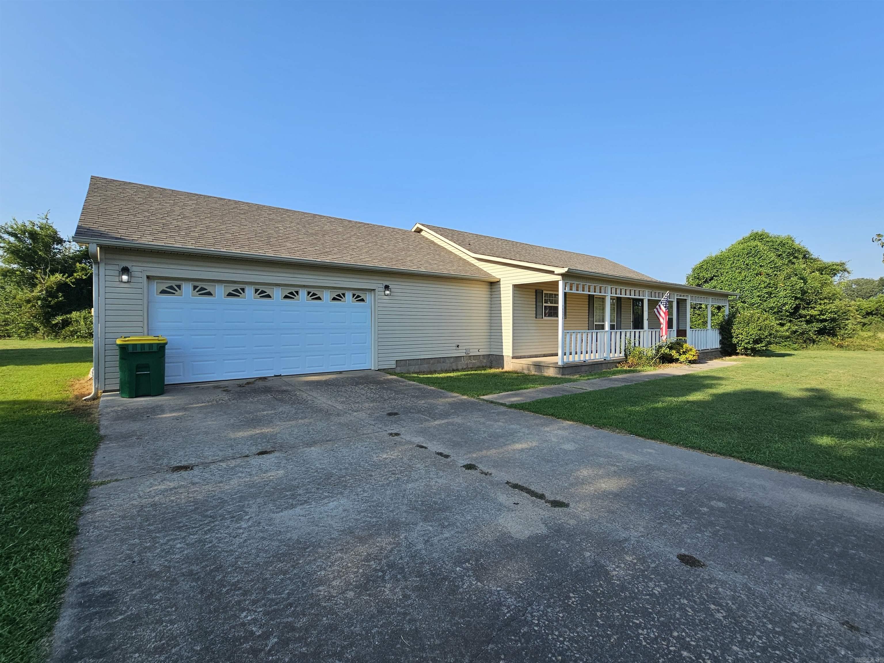 Country living yet not far from town. One story, split bedroom sitting on a half acre. Who doesn't love a front porch? As you enter the home, there is a dining room to the left and it's open to the great room with a gas log fireplace. The kitchen has plenty of cabinetry for the cook. The primary bedroom is large with a walk-in closet and attached to the closet is an office area or add a couple rods and make the closet even bigger. The 2 guest bedrooms are on the other side of the house along with a nice sized bathroom. You will enjoy time spent sitting in the sun room looking out over the backyard. The sunroom is heated and cooled. The lot is level and is complete with an in-ground storm shelter. This home is ready for you to come put your touches on it and make it your own.