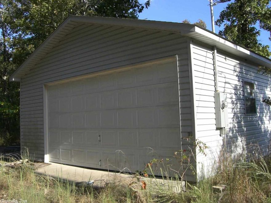 Pretty secluded land with a garage on it.