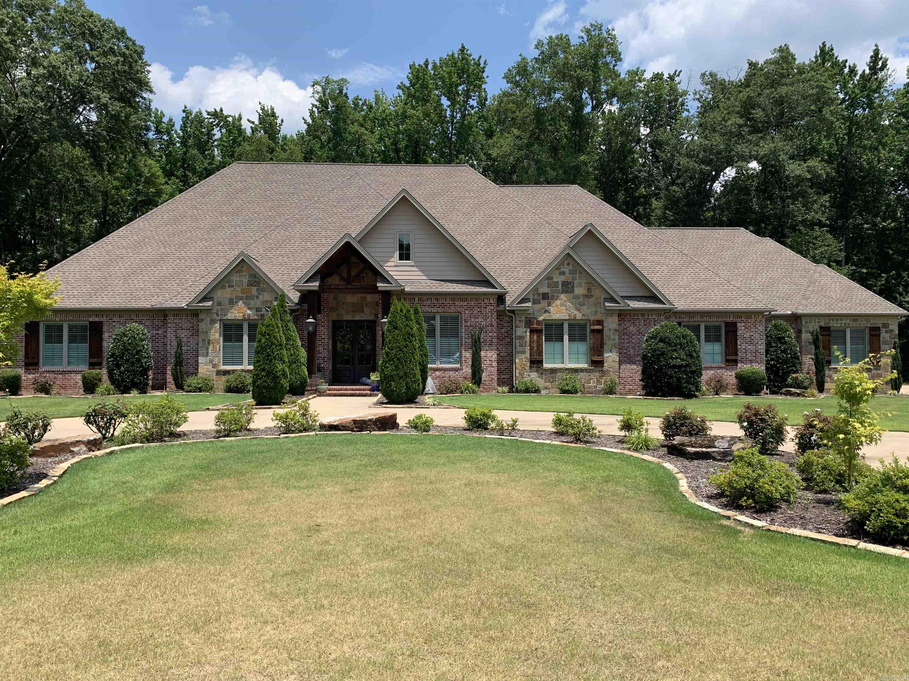 A circular drive and ample parking for family or guests. The living room that is open to the dining room, breakfast room and kitchen. The kitchen is perfect for a casual cook or a gourmet chef with so many convenient features including a walk-in pantry. Outdoor living space includes a kitchen.