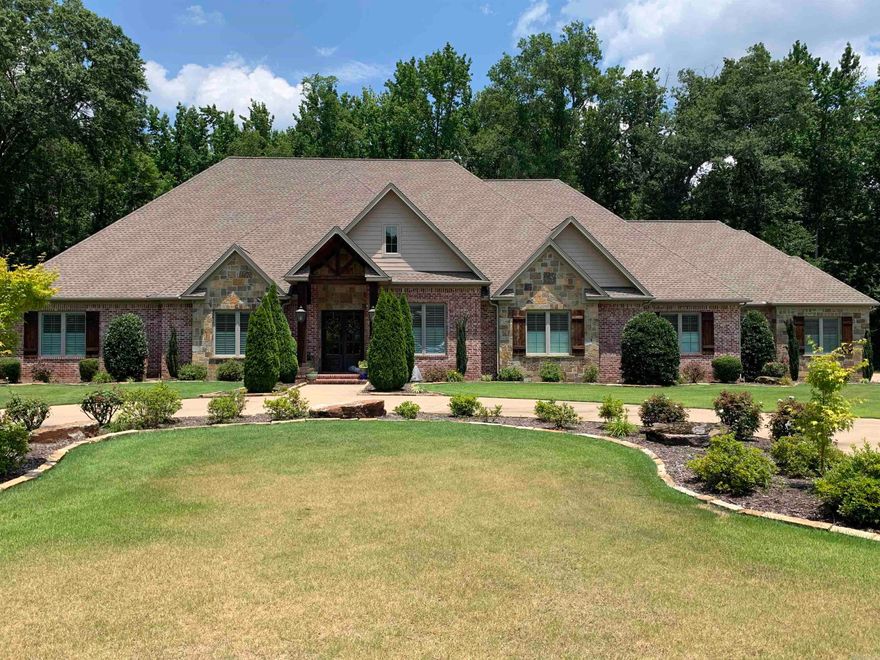 A circular drive and ample parking for family or guests. The living room that is open to the dining room, breakfast room and kitchen. The kitchen is perfect for a casual cook or a gourmet chef with so many convenient features including a walk-in pantry. Outdoor living space includes a kitchen.