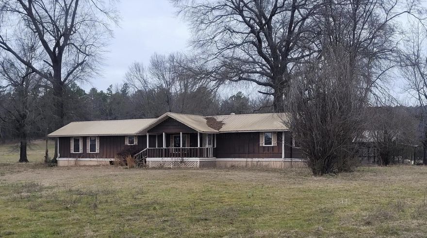 7 Beautiful Rural acres. Nested in the countryside, this 7 acres property offers peace, privacy, and endless possibilities.  Equipped with water, electric and septic. An older 3 bedroom, 2 bath mobile home is included AS-IS and could be repaired or replaced to fit your needs. Also included is a 30' x 44' includes a 24' x 10' fully enclosed space, perfect for storage or a workshop.