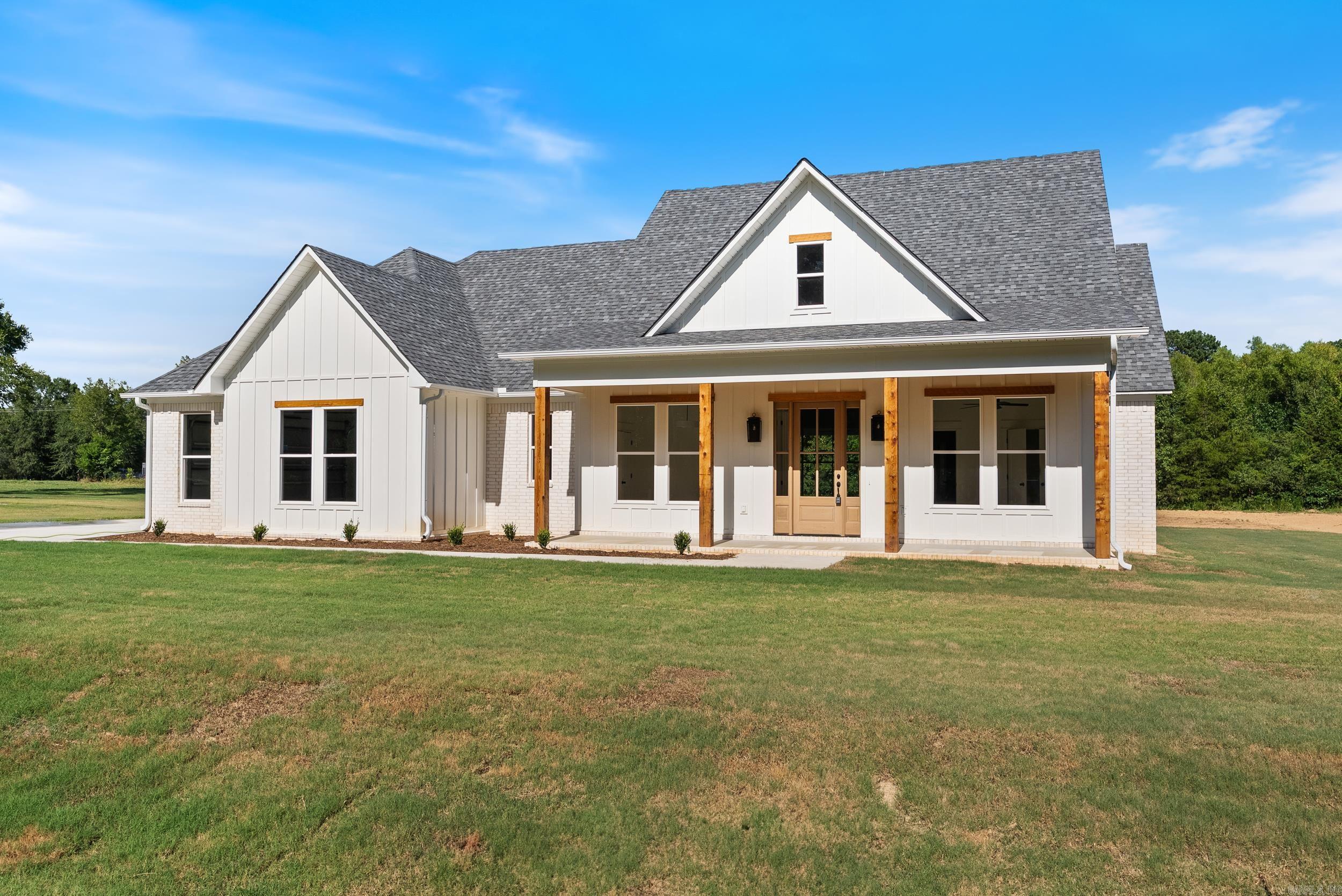 This 4-bedroom home with an office sits on a flat 1.23 acre lot with plenty of space to add a shop. Inside features include custom cabinets, quartz countertops, tile showers, an electric fireplace, and oversized windows for natural light. The large covered patio offers outdoor living space with a view of the open backyard.