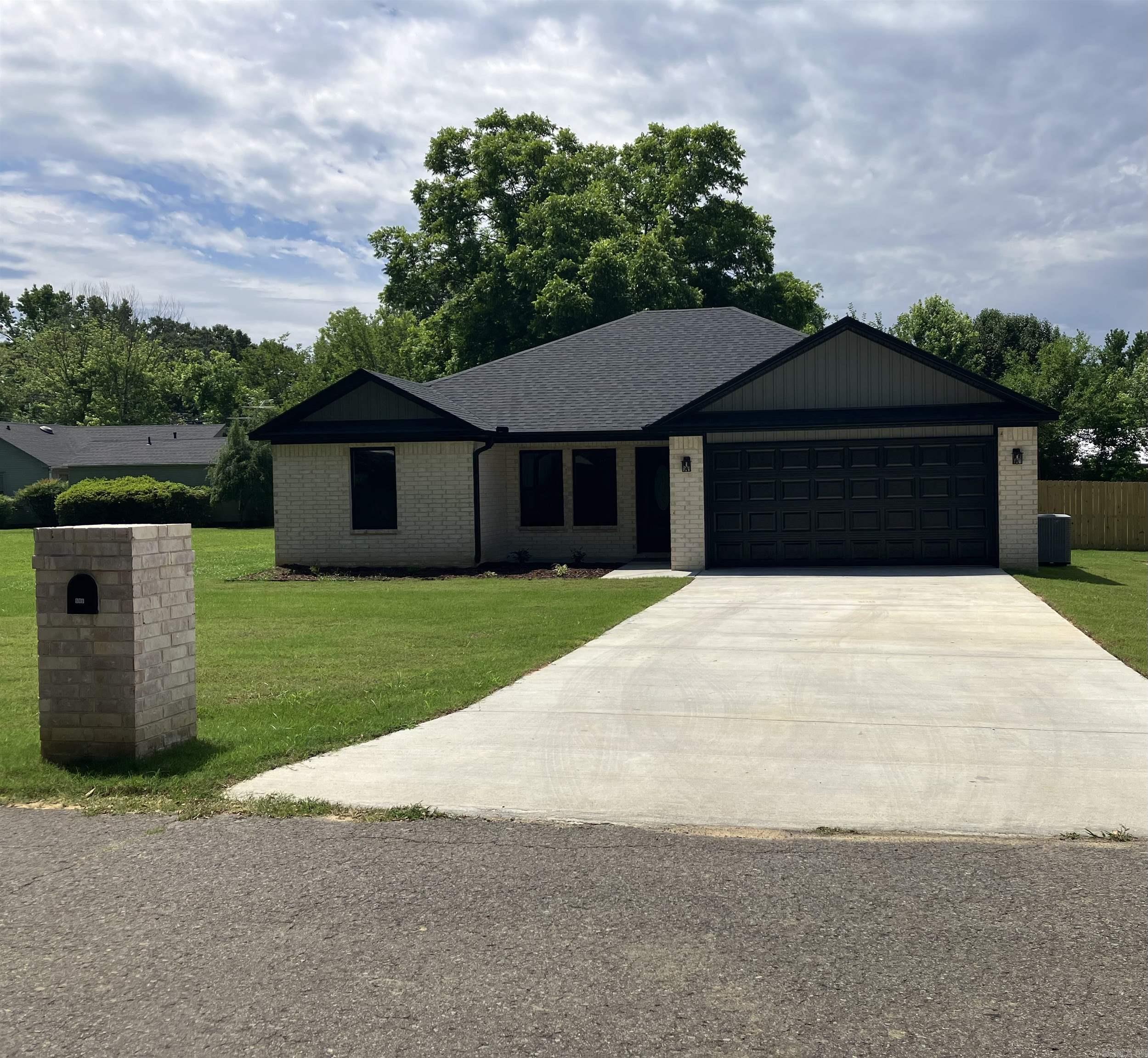 599 W Indiana, Beebe AR 72012 - Step into your dream home, where modern sophistication meets small-town charm! This stunning new brick construction is perfectly situated in a cozy neighborhood, offering the ideal blend of convenience and tranquility. You'll love being just minutes away from schools, shopping centers, and easy interstate access for seamless city travelāall while enjoying the peace of small-town living. Inside, this open-plan masterpiece features elegant crown molding enhancing its appeal. The master suite boasts a striking pan ceiling that elevates the room's grandeur, while the vaulted ceiling in the living area creates character. The kitchen shines with granite countertops and sleek cabinetry, offering a sophisticated hub for family gatherings. Unwind in the luxurious master suite, where modern comfort meets indulgence. Enjoy the marble-accented walk-in rain-head shower, or relax in the freestanding tub for ultimate tranquility. This home is thoughtfully designed with you in mind. Covered porch and fenced backyard. Schedule your showing today!