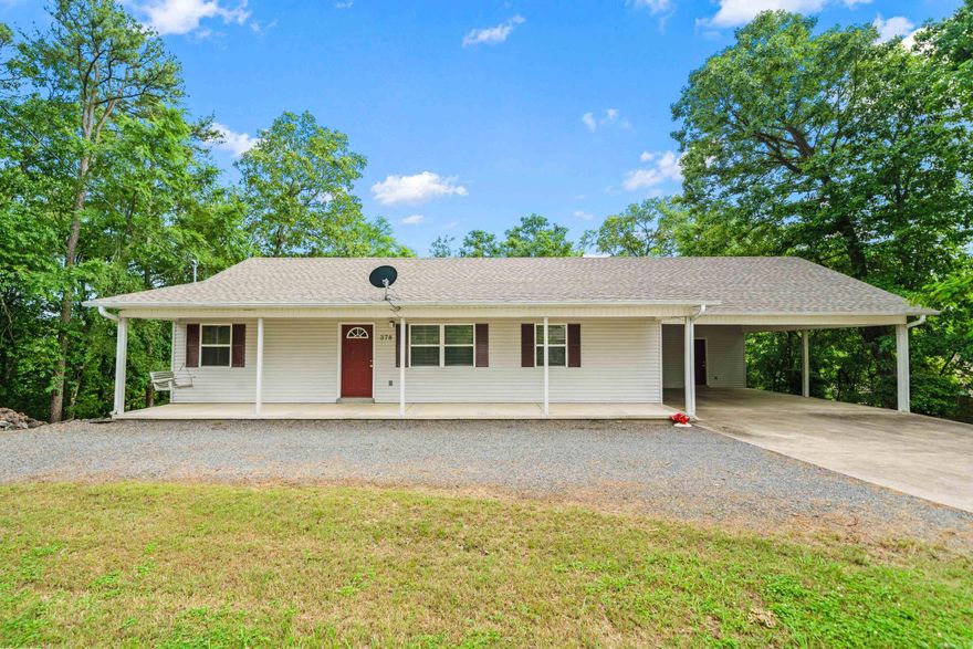Clean and well kept 3/2 with lake access on Lake Hamilton. New heat and air in 2022, new architectural shingle roof in 2023. Circle driveway, 2 car carport, storage room off carport. Fully fenced back yard. Full width front porch with partial lake view. 13.5 X 12 covered deck with lower level patio. Full unfinished basement, with slab floor. Basement has block, sheetrock & OSB walls with unfinished sheetrock ceiling as well a a sink. Open split floor plan, 1320 square feet, knock down finish ceiling. Utility room with built-ins. Lake access 900 feet from home with launching ramp and picnic area. Optional $50 a year POA fee for lake access. Refrigerator is negotiable.