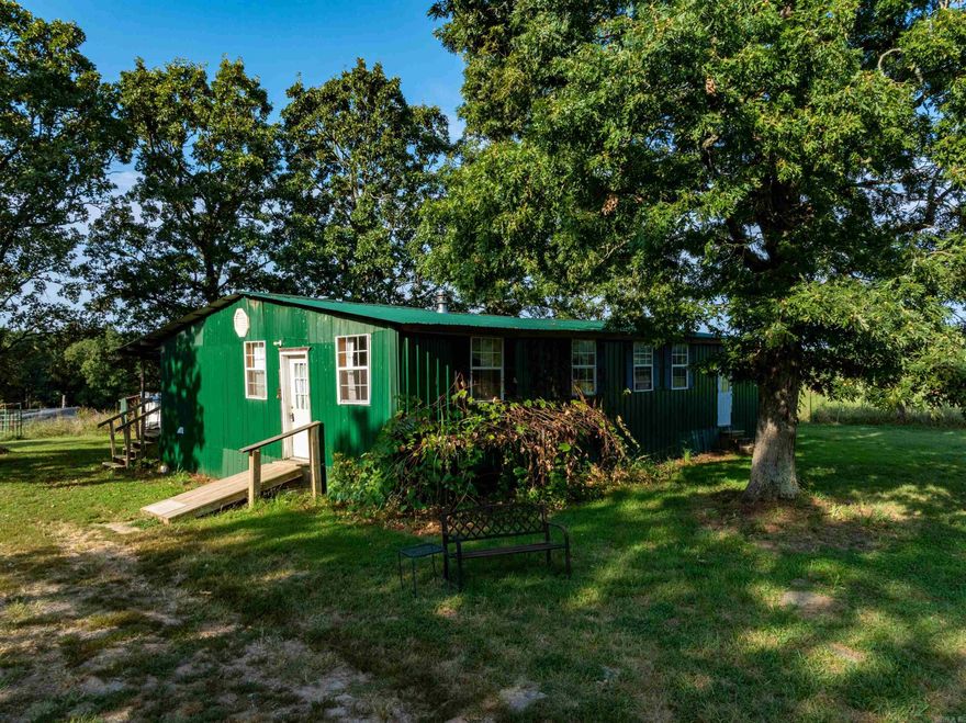 Rustic 3-bed, 2-bath cabin on 15± fenced acres in Floral, AR—minutes from Batesville. This 1,600± sq ft home features an open layout, roomy laundry, and oversized walk-in pantry. The 800 sq ft covered back porch overlooks open pasture with frequent deer, turkey, and other wildlife sightings. Property includes fully fenced/cross-fenced pastures (owner cuts hay), pond with automatic livestock waterer, animal pen, chicken coop, storage shed, gated entry, and tree-lined borders for privacy. Utilities: Southside Water, Entergy Electric, 1,000-gal septic. All furnishings, equipment, and items on-site convey.  Outdoor enthusiasts will love the proximity to Jamestown Wildlife Management Area, offering thousands of acres of public hunting for deer, turkey, and small game—making this an ideal hunting basecamp.  Perfect for a turnkey homestead, hunting lodge, or private country retreat with easy access to town.