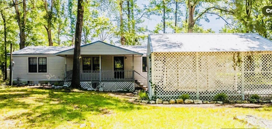 Fisherman Dream lakefront Mobile Home sitting on 1.12 acres on Lake Conway..New flooring,new added Sun Porch.Boat Dock,shop with a two car garage with electric.Very Private Property.Move in ready.