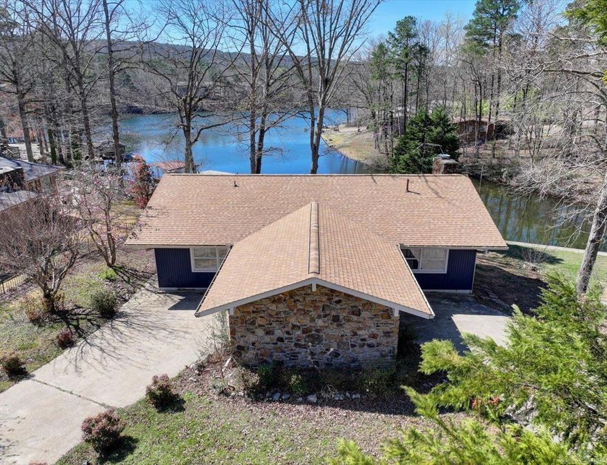 LAKEFRONT SINGLE FAMILY HOME WITH MODERN UPGRADES. This beautiful 3 bed, 2 bath lakefront home is nestled along the serene shores of Lake Desoto, making it an ideal year-round retreat or vacation rental. Recent updates include: New HVAC - March 2024 New compressor - October 2024. New roof - October 2024. New water heater - June 2024. Updated walls in dining room - October 2024. New oven - 2024. New stone patio and deck by the lake - 2023.  New laminate flooring in the living room and guest bedroom. Fresh paint in the entire home - indoor and outdoor. Property features include: Spacious stone patio with firepit by the lake and covered boat dock with a slip.  Beautiful stone fireplace in the living room and water views from the master suite. Additional storage is available in the carport and the crawl space.  This charming lakefront home offers tranquility and functionality. Whether you're enjoying the expansive deck, paddling on the lake, or cozying up by the fire, every day feels like a getaway. Come and see!  Currently a short term rental.  Furnishings, all appliances, and kayaks may be included with an acceptable offer.  Agents - Call Showing Service to schedule all showings.