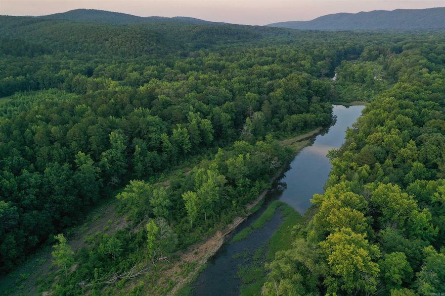 • 27 +/- Acres • Fourche LaFave River Frontage • Ouachita National Forest Boundary • County Road Frontage • Small Cabin • Excellent Hardwood and Pine Timber • Pond • ATV trails • Rainwater collection system • Storage building • Trail down to water’s edge • Electricity • 20 Minutes from Waldron