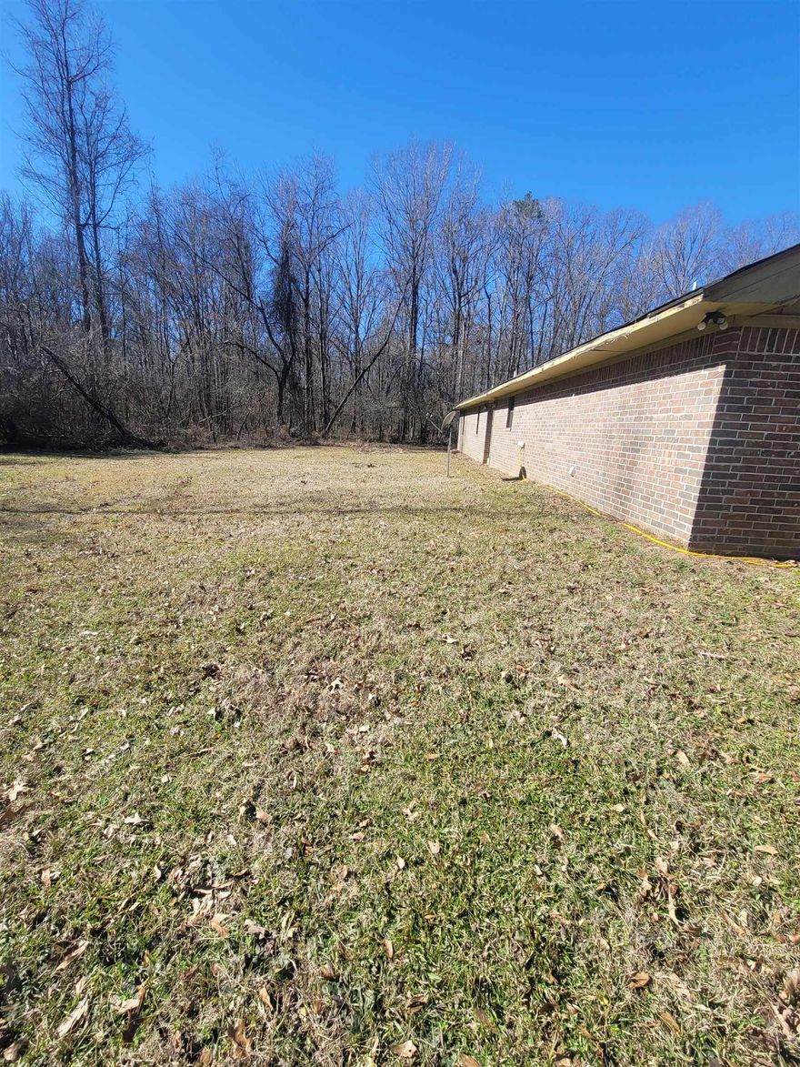 Roll up your sleeves and enter the gates to your country estate! This mostly wooded and flat 8.75 (+/-) acres screams potential with an all brick 2-bedroom, 2-bath home. It's the opportunity every buyer is looking for that longs for county living. Inside, you'll find spacious rooms and an open layout, though some updates and few repairs are needed you can see the dream. Whether you're an investor, or someone looking for a fun renovation project, this property is for you. (Please do not disturb occupant)